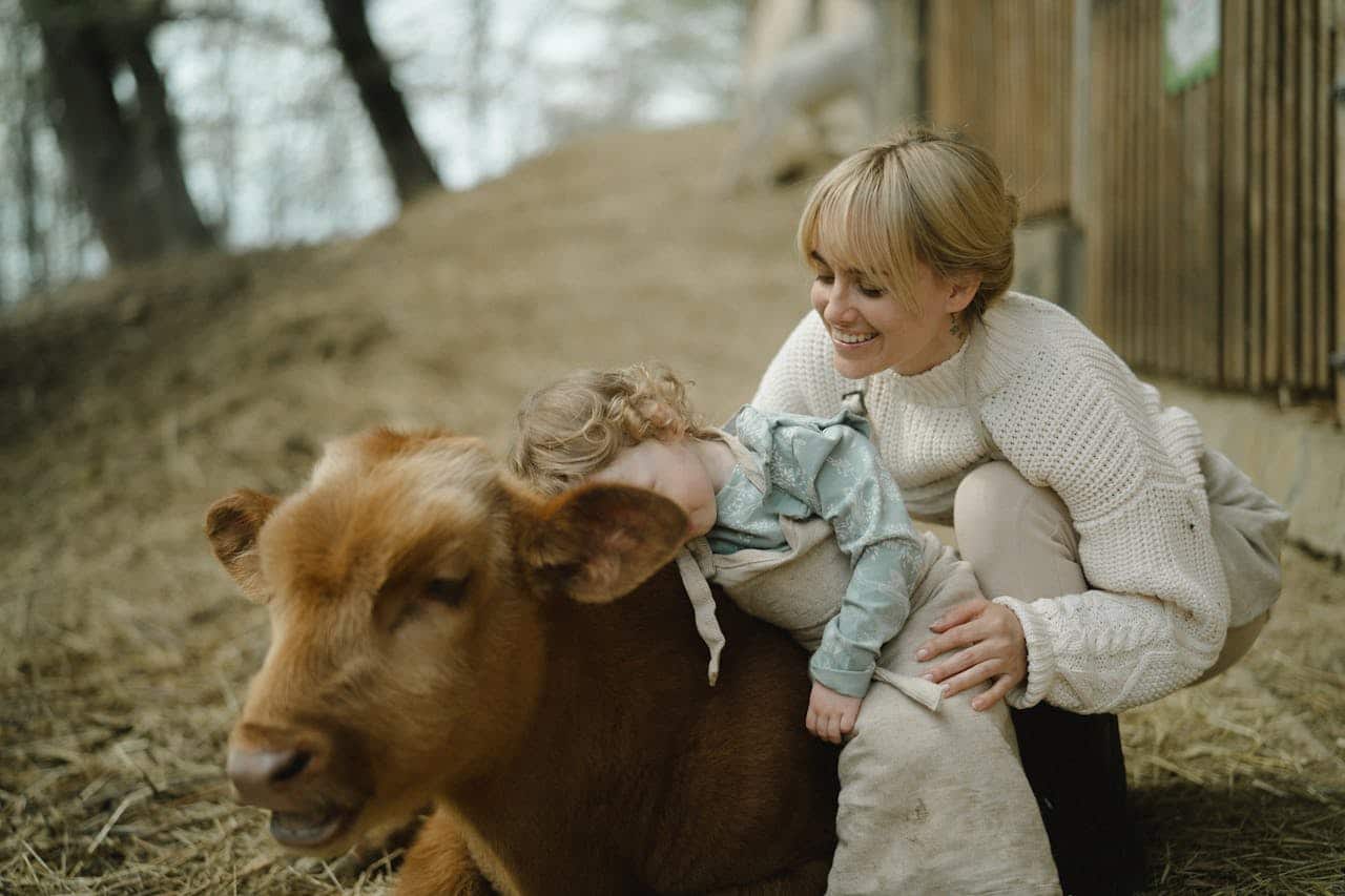 Photo by  Anastasia  Shuraeva: https://www.pexels.com/photo/mother-and-daughter-petting-a-calf-in-a-farm-7673845/