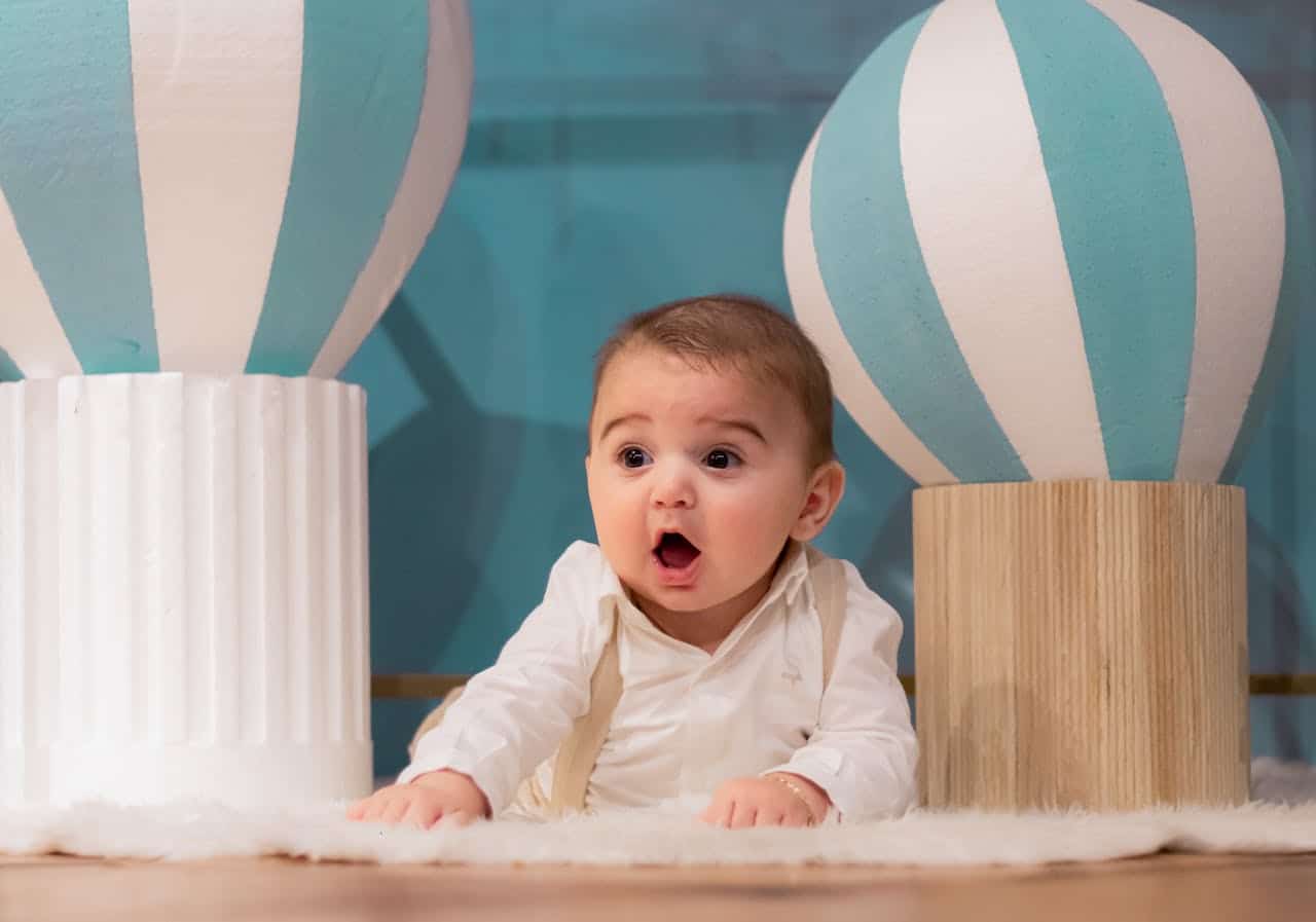 Photo by Larbigno •: https://www.pexels.com/photo/adorable-baby-surprised-amidst-balloon-decor-28992484/