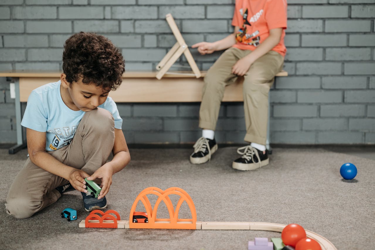 Photo by Pavel Danilyuk: https://www.pexels.com/photo/boy-playing-with-cars-and-wooden-track-8441848/