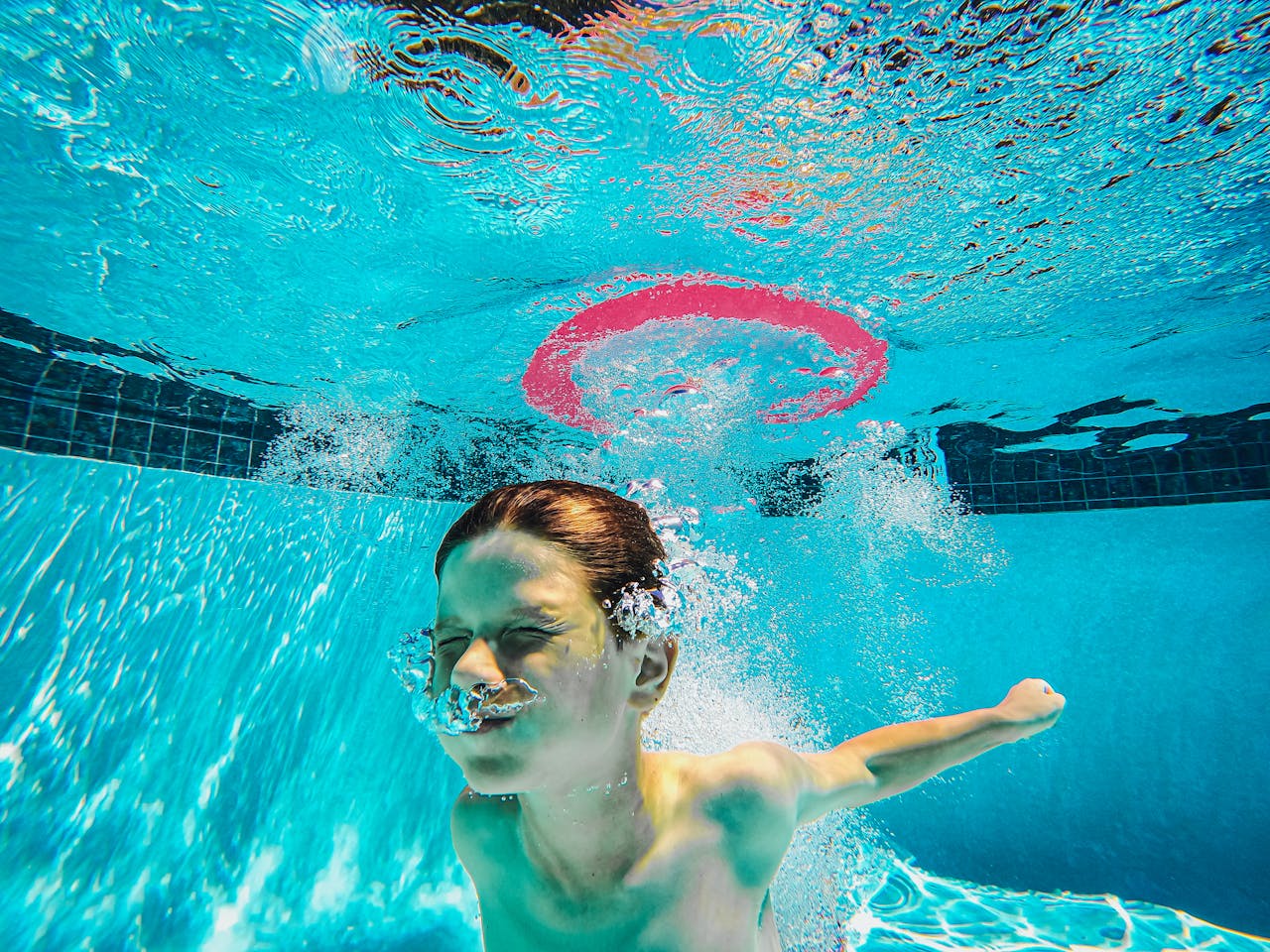 Photo by Kindel Media: https://www.pexels.com/photo/a-boy-in-a-swimming-pool-9044086/